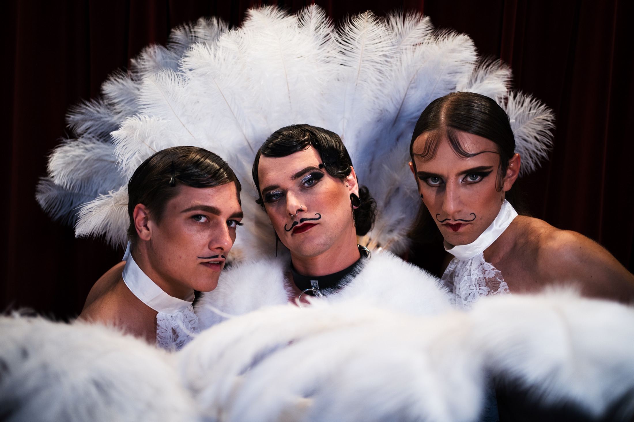 Cabaret trio with white feathers