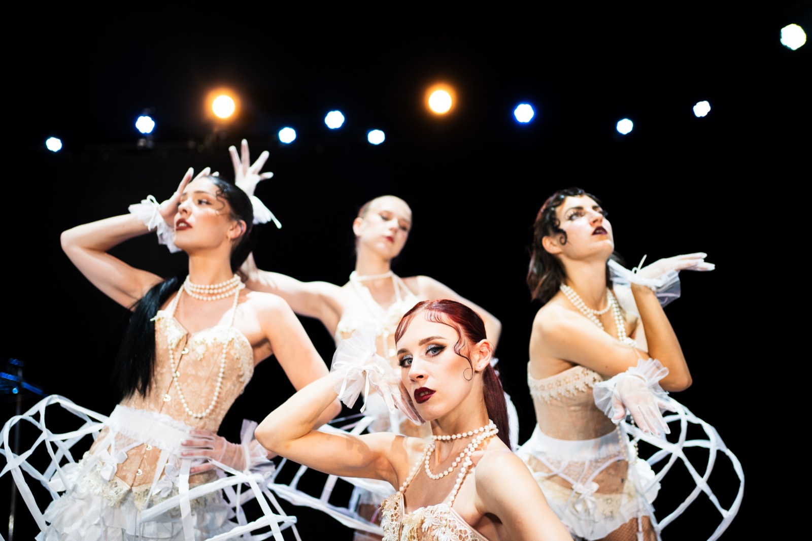 Cabaret ensemble in white costume world